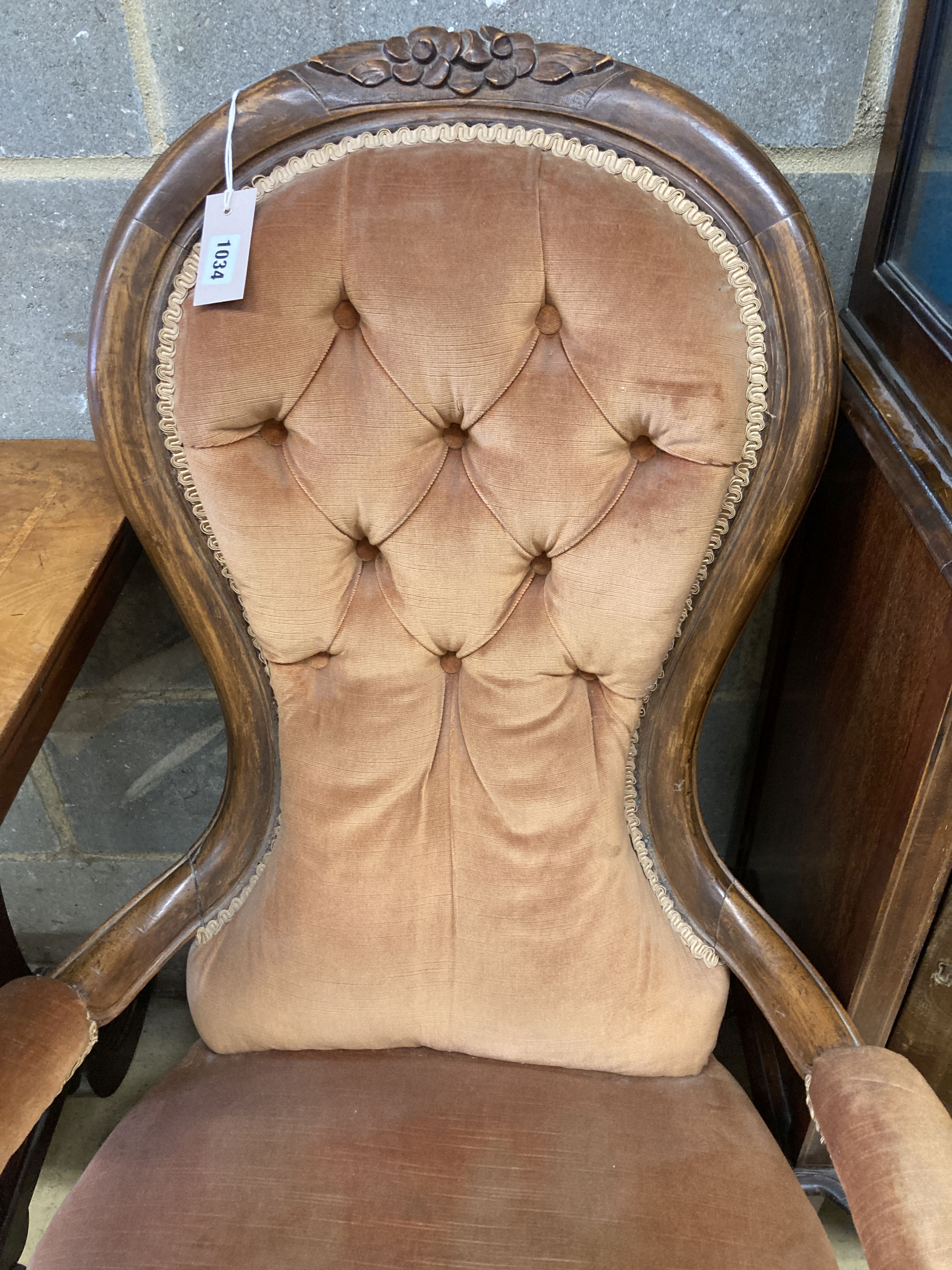A Victorian walnut spoonback open armchair
